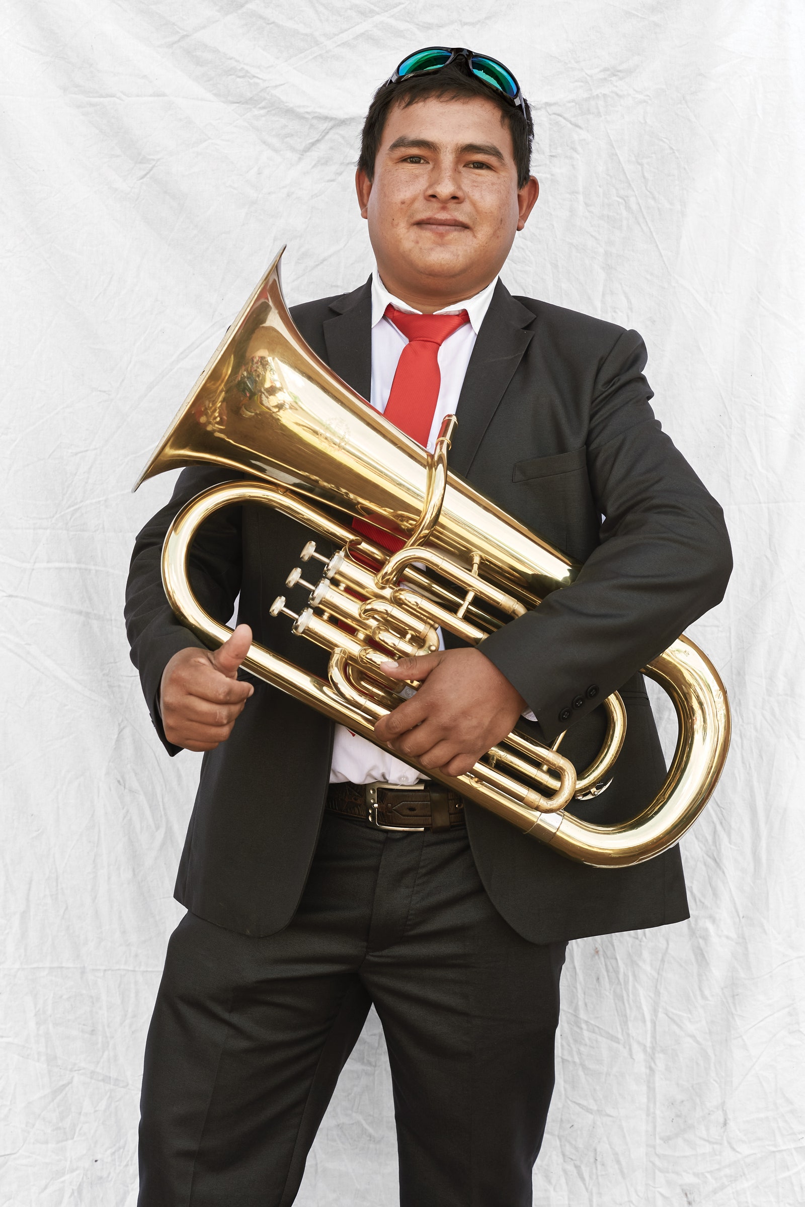 Image may contain Accessories Tie Accessory Musical Instrument Tuba Horn Brass Section Euphonium Human and Person